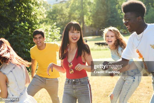 group of friends having fun - woman smiling park summer stock-fotos und bilder