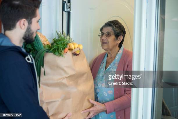 home delivery - old woman young man stock pictures, royalty-free photos & images