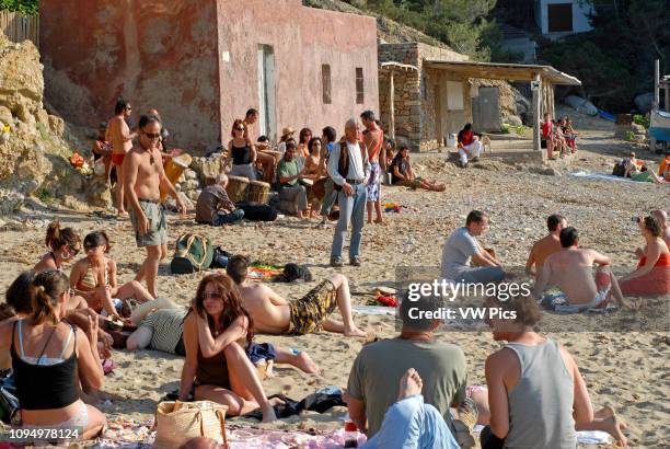 People enjoying sundays in popular Benirras beach, where drum players play until sunset, Ibiza, Spain.