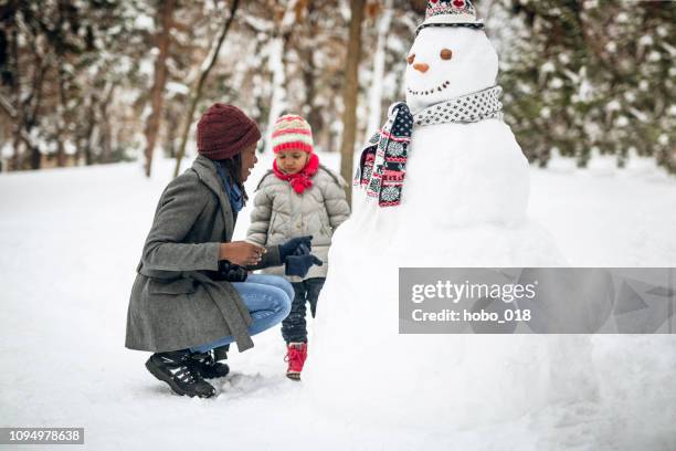 schneemann mit freunden und familie - frau schneemann stock-fotos und bilder