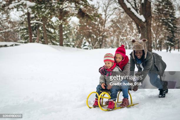 single mom playing with kids - family snow stock pictures, royalty-free photos & images