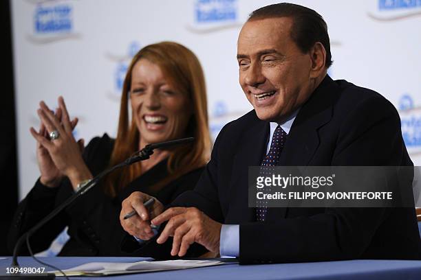 Italian Prime Minister Silvio Berlusconi and tourism minister Michela Brambilla speak Italian Prime Minister Silvio Berlusconi and tourism minister...