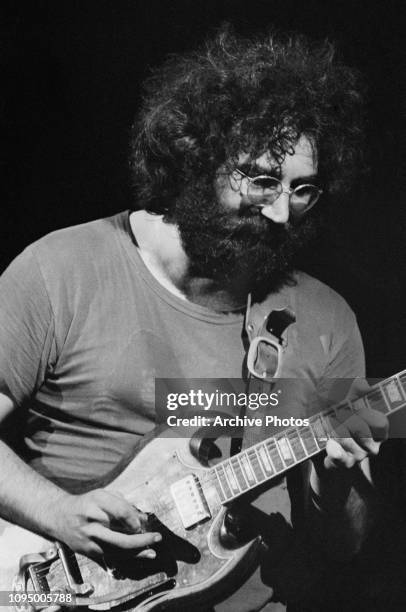 Singer and guitarist Jerry Garcia performing with American rock group The Grateful Dead, at the Woodstock Music Festival, Bethel, New York, 16th...