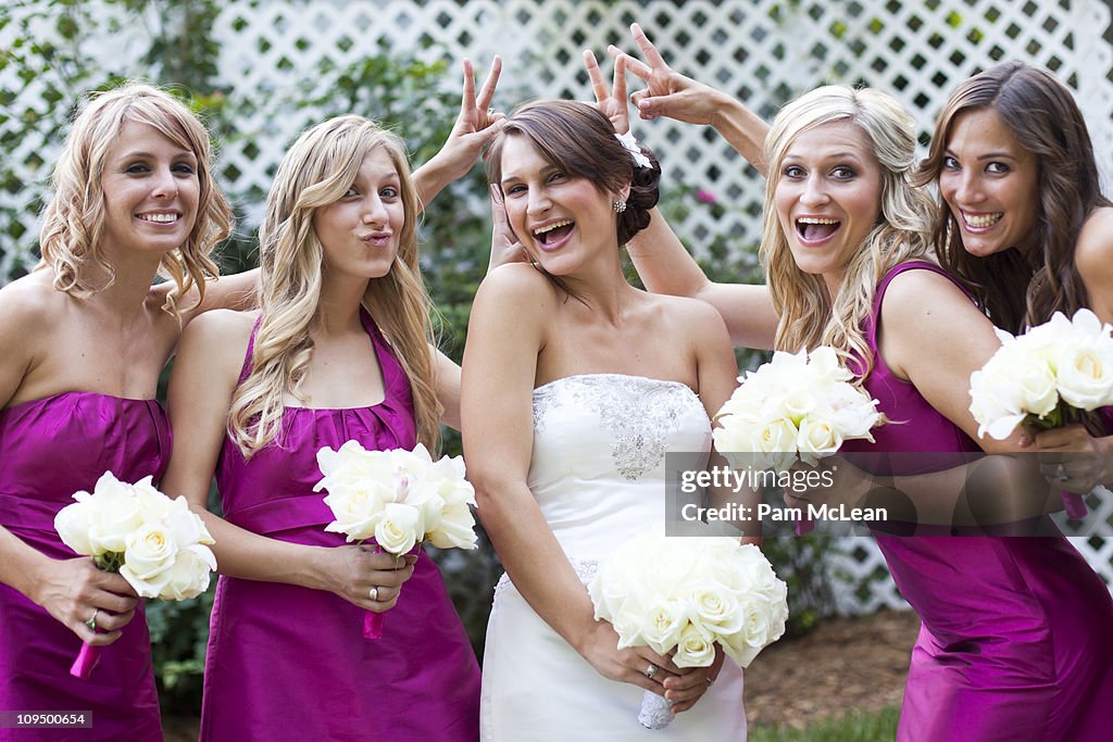 Bride posing with her bridesmaids.