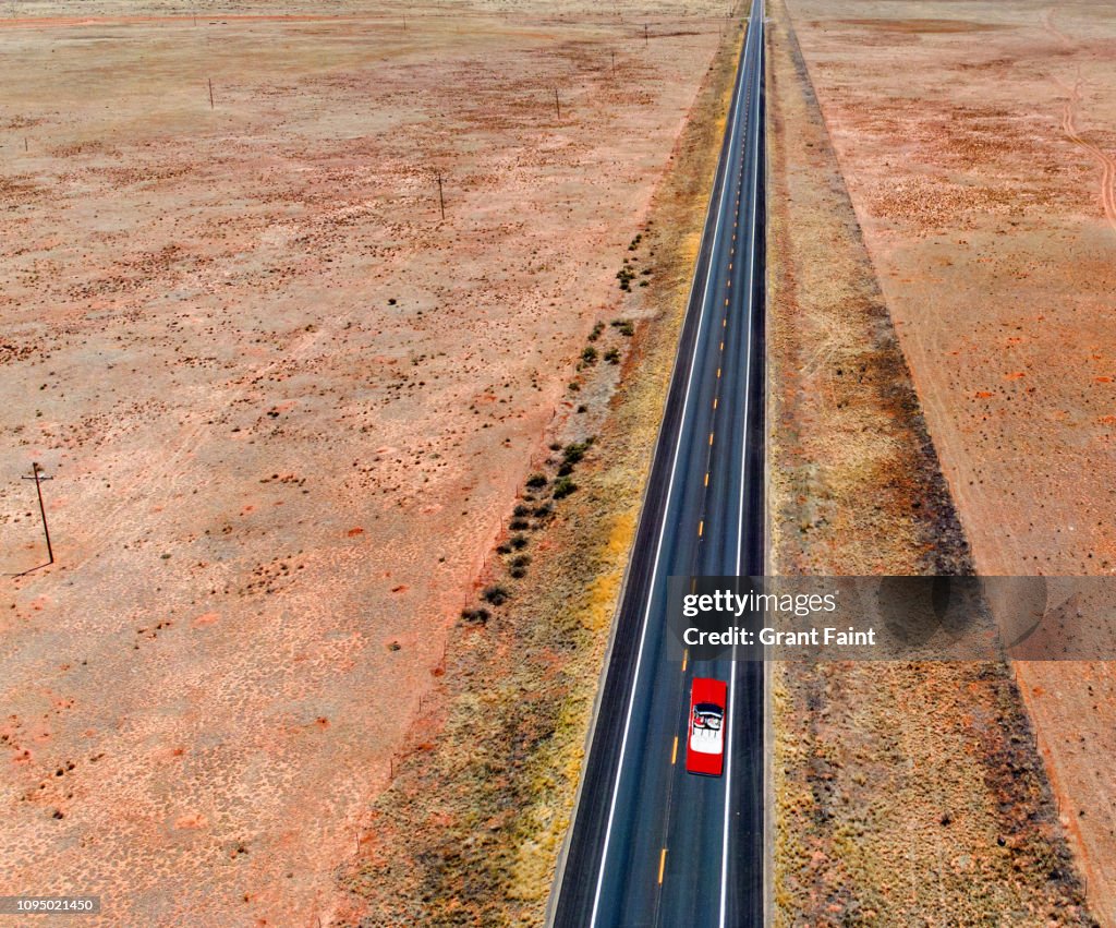 Red car moving down highway