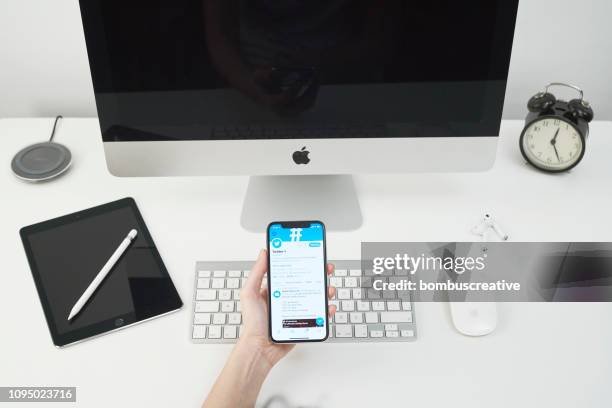 twitter profile on apple iphone x - looking at iphone x stock pictures, royalty-free photos & images