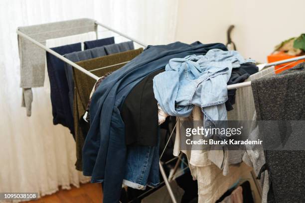 laundry day chaos - hanging clothes stock-fotos und bilder