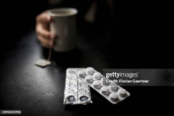 In this photo illustration tablets are pictured in front of a cup of tea on February 05, 2019 in Berlin, Germany.