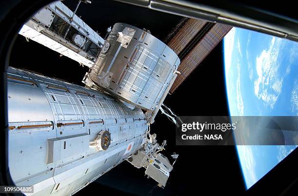 In this handout image provided by NASA, backdropped by the blackness of space and Earth's horizon, the Japanese Kibo complex of the International...