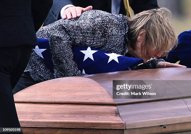 Cynthia Pyeatt stands over the casket of her son U.S. Marine Corporal Lucas T. Pyeatt during a funeral service at Arlington National Cemetery...