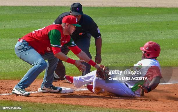 Yubiesky Laurdet of Cuba's Lenadores de las Tunas save the base against Agustin Murillo of Mexico's Charros de Jalisco during the Caribbean Series...