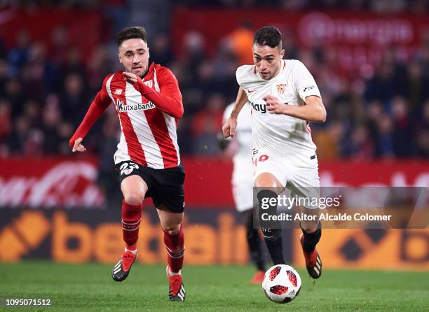 Munir El Haddadi of Sevilla FC competes for the ball with Unai Lopez of Athletic Club during the Copa del Rey Round of 16 second leg match between...