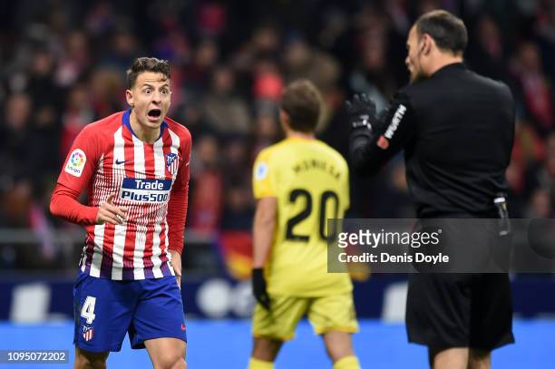 Santiago Arias of Club Atletico de Madrid speaks to referee Antonio Mateu Lahoz after his goal was ruled out via VAR during the Copa del Rey Round of...