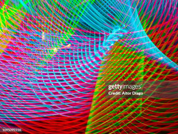 blue, green, pink and red curved lines forming a net in 3d. - surround sound stock-fotos und bilder