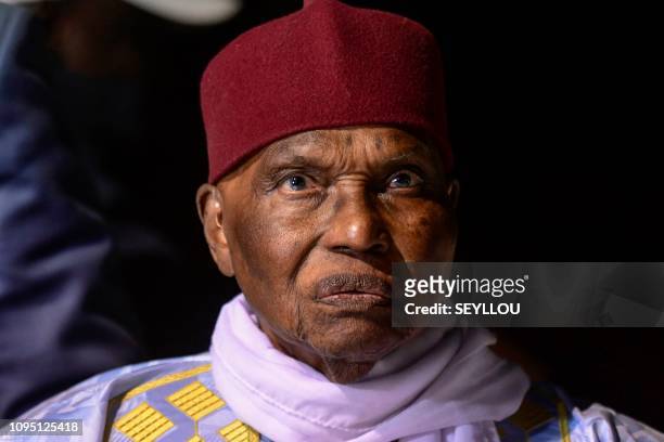 Former Senegalese president Abdoulaye Wade looks on as he arrives at his party headquarters, in Dakar, on February 7, 2019. - Abdoulaye Wade returns...