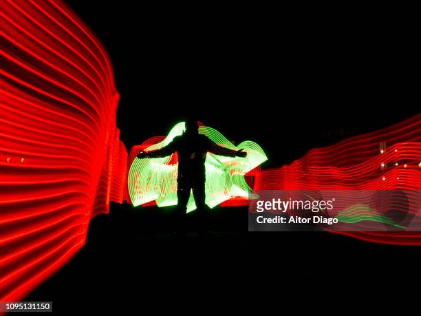 human figure with open arms in a futuristic, virtual robotic environment. 3d. light painting - people white background stock pictures, royalty-free photos & images