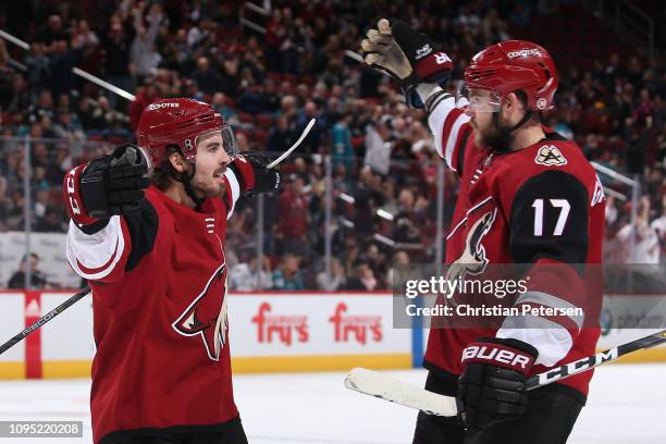 Conor Garland and Alex Galchenyuk of the Arizona Coyotes celebrate after Galchenyuk scored a goal against the San Jose Sharks during the third period...