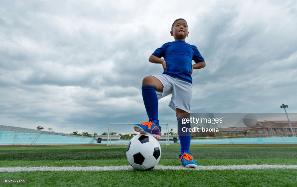 Young football player waiting for kick off