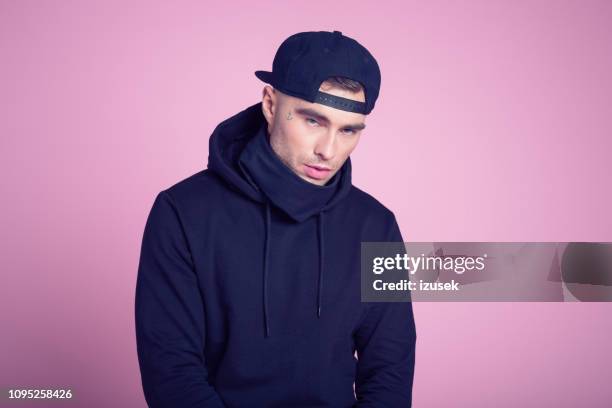 portrait of rapper wearing hooded shirt - gangster rap stock pictures, royalty-free photos & images