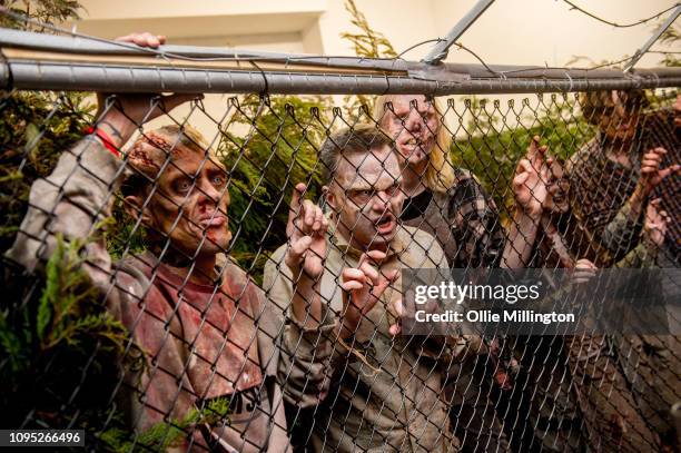 The Walking Dead Zombie actors in character seen in an immersive display recreating a scene from the Terminus story arc of seasons 6 and 7 during The...