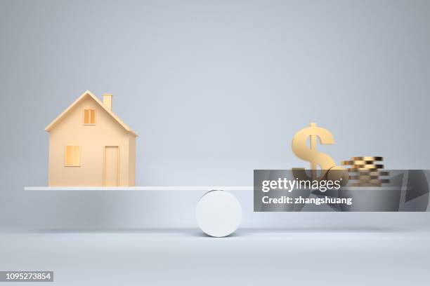money and mortgage house - seesaw balance stock pictures, royalty-free photos & images
