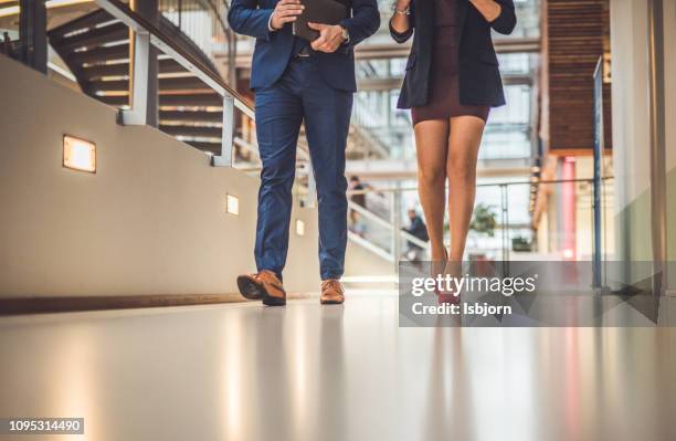 close up of unknown female and male walking together. - male feet imagens e fotografias de stock