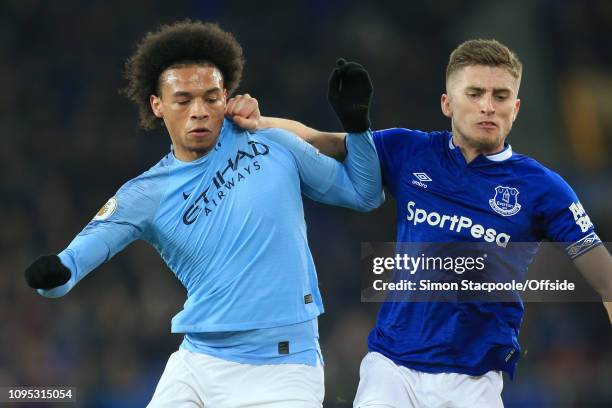 Leroy Sane of Man City tussles with Jonjoe Kenny of Everton during the Premier League match between Everton and Manchester City at Goodison Park on...