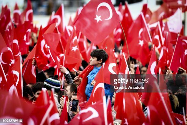 Child is seen as citizens attend Turkish President and leader of Turkey's ruling Justice and Development Party Recep Tayyip Erdogan's party campaign...