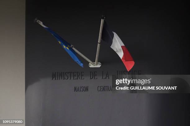 Picture taken on February 08, 2019 shows a Eropean and a French flag on a wall of the Saint-Maur prison where French national Jean-Claude Romand,...