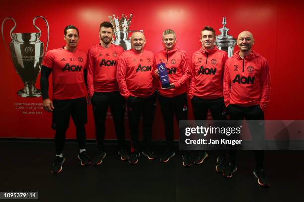 Ole Gunnar Solskjaer poses with his Barclays manager of the month award and coaching staff at Aon Training Complex on February 07, 2019 in...