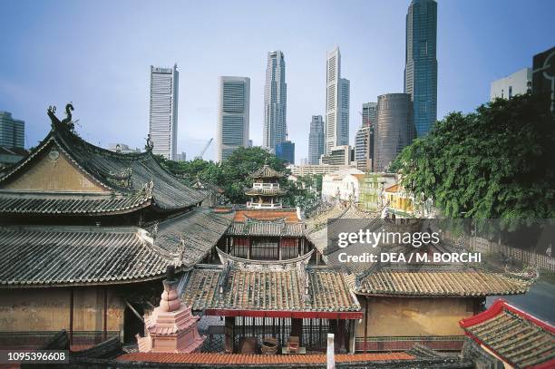 Roofs of the Thian Hock Keng temple in the Chinatown district, with the Central Business District skyscrapers in the background, Singapore.