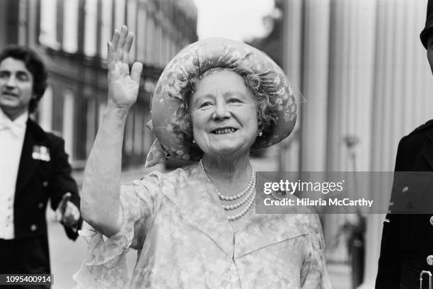 Queen Elizabeth, the Queen Mother , waves to the crowd who have gathered outside Clarence House, her London home, to wish her a happy 78th birthday,...