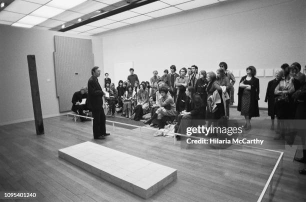 Curator giving a talk to visitors at the Tate Gallery, now known as the Tate Britain, London, UK, 6th April 1977.