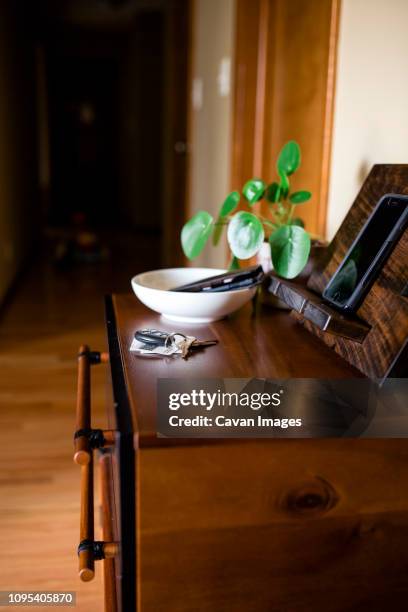 close-up of smart phone with car keys and credit cards on wooden table at home - dish networks stock pictures, royalty-free photos & images