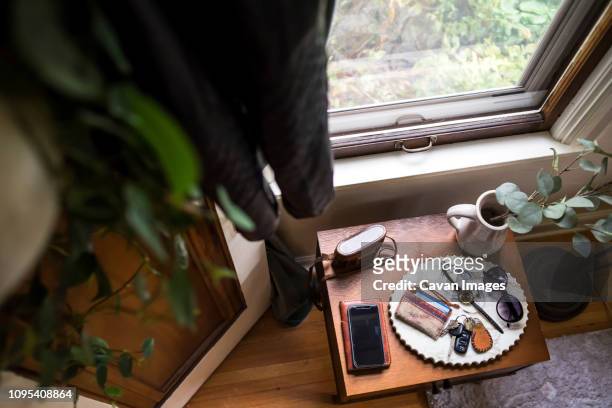 High angle view of accessories in plate on table by window at home