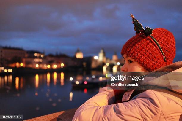 portrait of a cheerful young girl with christmas mood at dusk. - prague christmas stock pictures, royalty-free photos & images