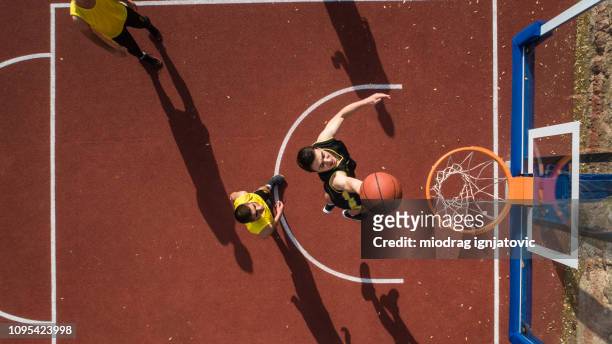 basketball-spieler machen slam dunk - basketball sport stock-fotos und bilder