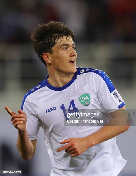 Eldor Shomurodov of Uzbekistan celebrates as he scores his team's first goal during the AFC Asian Cup Group F match between Japan and Uzbekistsn at...