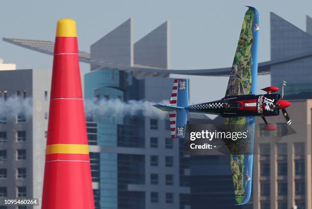 Petr Kopfstein of Czech Republic manoeuvres his plane during the qualifying round of the Red Bull Air Race World Championship in the Emirati capital...