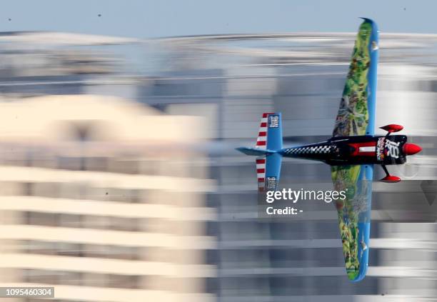 Petr Kopfstein of Czech Republic manoeuvres his plane during the qualifying round of the Red Bull Air Race World Championship in the Emirati capital...
