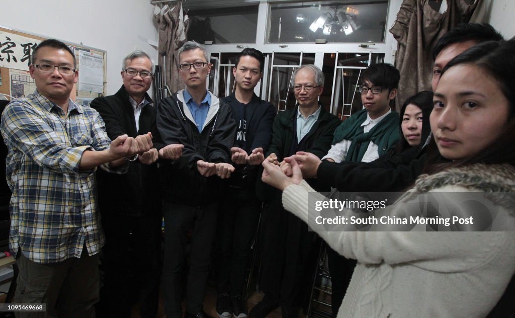 (L to R) Occupy Central volunteers who plan to surrender on Saturday Cliff Cheung Chi-fai, Fung Tak-wah, Andy Wong Hiu-hei, Kent Lam Yung-ki, Lau Kwong-kit, Chan Yu-cheung, Mabel Yip Ka-po, Siu Chiu-kit and Yeung Pui-yan, pose for a photograph at Office o