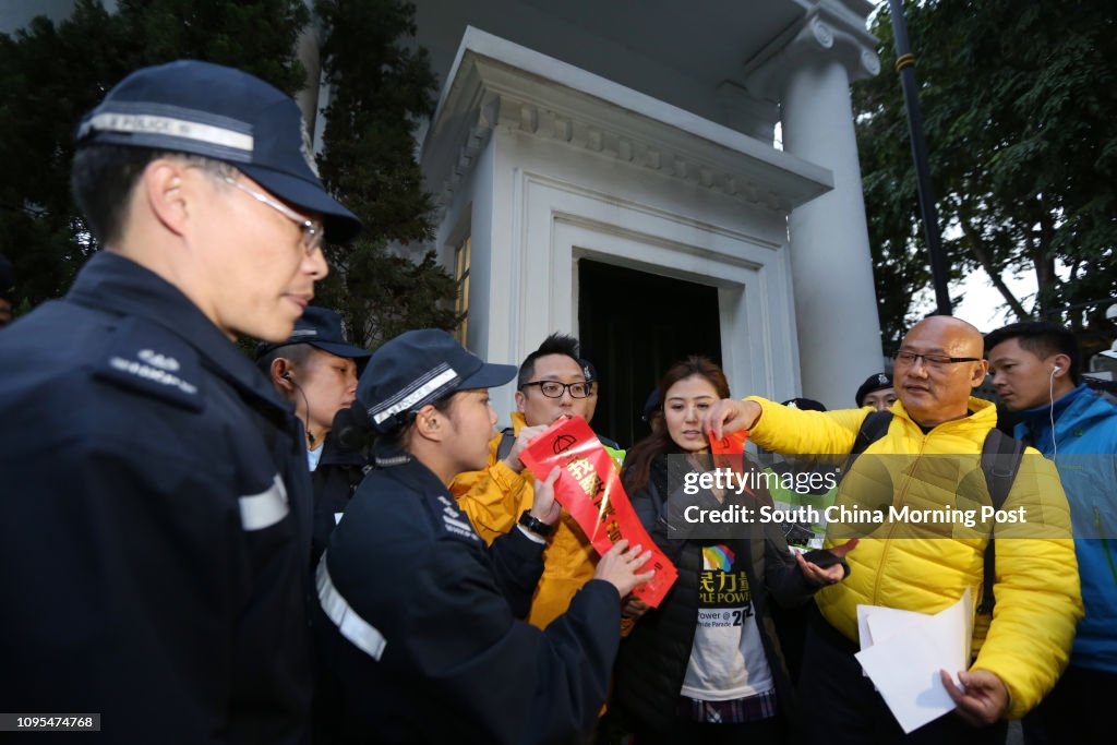 (L-R) Tam Tak-chi, Erica Yuen Mi-ming and Albert Chan Wai-yip of People Power attempt to put up "fai chun" outside Government House in Admiralty to demand universal suffrage. 01FEB15