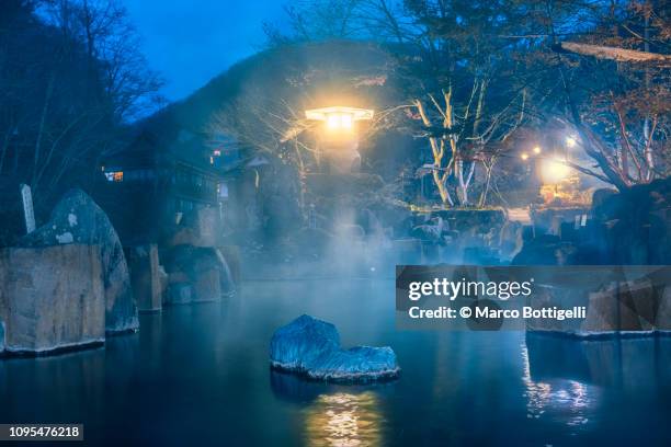 japanese hot spring (onsen) illuminated at dusk, japan - smokey mountain spring stock pictures, royalty-free photos & images