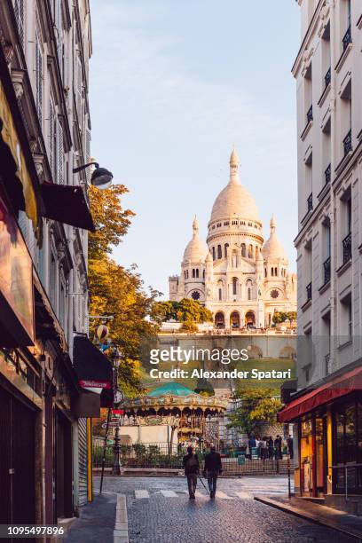 streets of montmartre and sacre-coeur basilica on the hill, paris, france - paris france stock-fotos und bilder