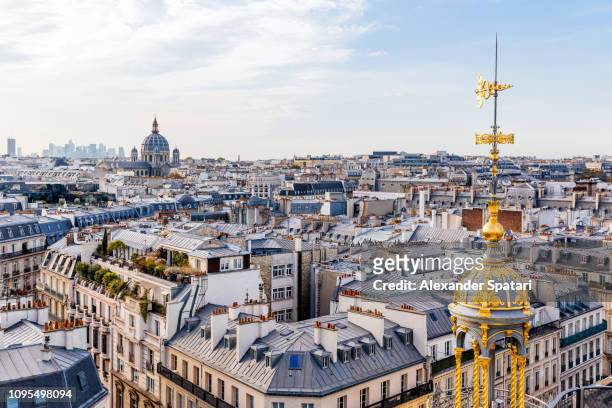 high angle view of paris skyline with rooftops and church of st. augustine, paris, france - monuments paris foto e immagini stock
