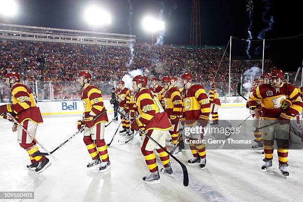 Teammates of the Calgary Flames shake hands with the Montreal Canadiens on February 20, 2011 after the 2011 Heritage Classic at McMahon Stadium in...