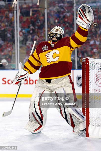 Miikka Kiprusoff of the Calgary Flames reaches to catch the puck against the Montreal Canadiens on February 20, 2011 during the 2011 Heritage Classic...