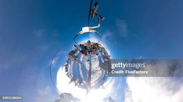 skiers riding a cable car to the top of the mountain - little planet effect stock pictures, royalty-free photos & images