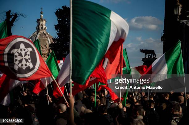 Members of the Italian far-right political party Casapound wave Italian flags during a demonstration against the mayor of Rome, on February 8, 2019....