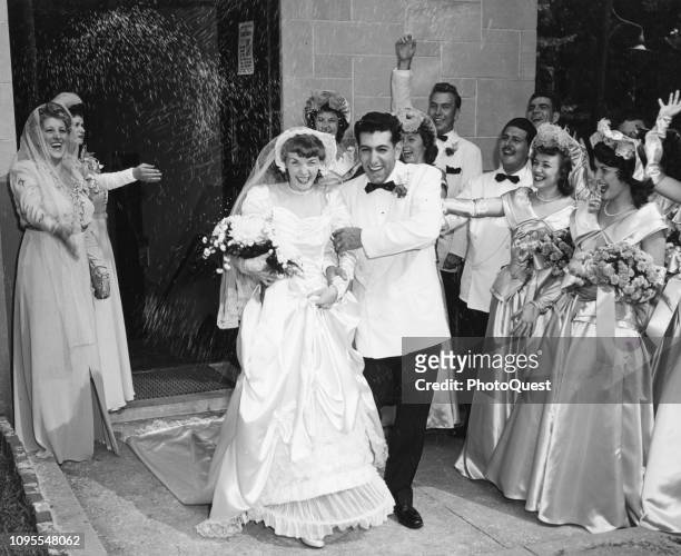 Newlyweds Doris and William Richard Greco laugh as they pass under a traditional shower of rice, thrown by wellwishers, as they depart St Jerome's...